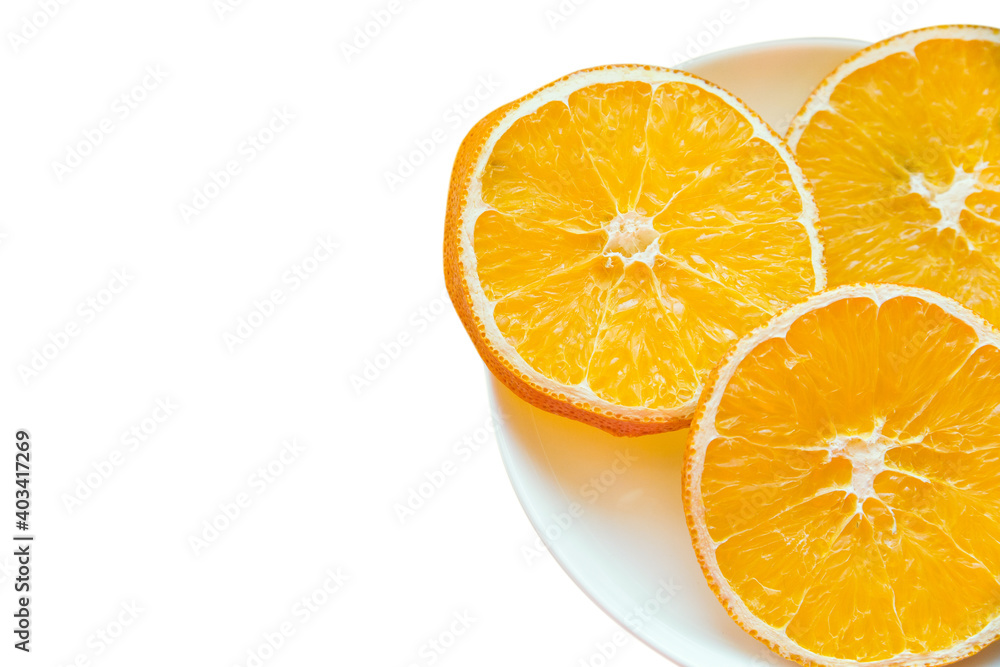 Plate with three slices of dried orange isolated on a white background with place for text. Copy space Plate with three slices of dried orange isolated on a white background with place for text. Copy space
