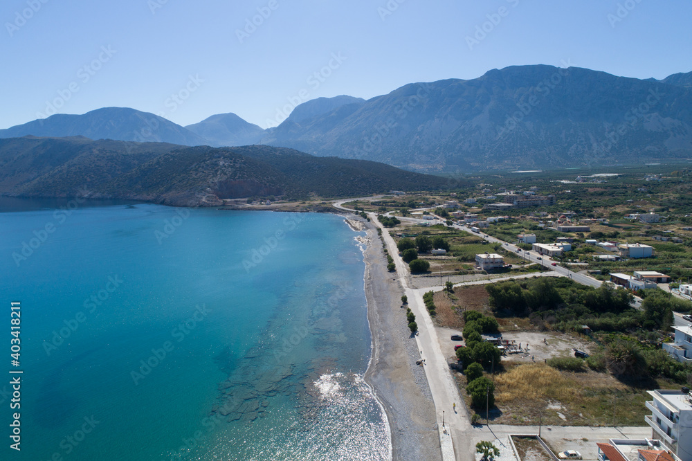 Beautiful landscape of the island from a bird's-eye view. View of the beach, mountains, trees and roads.