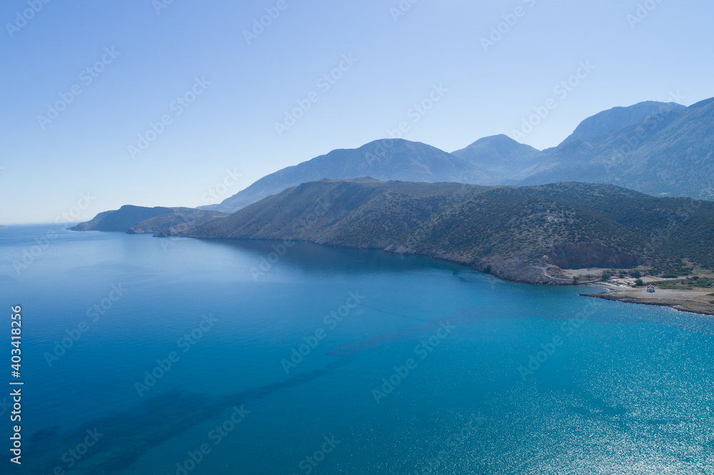 Beautiful landscape of the island from a bird's-eye view. Blue sky and sea, mountains.