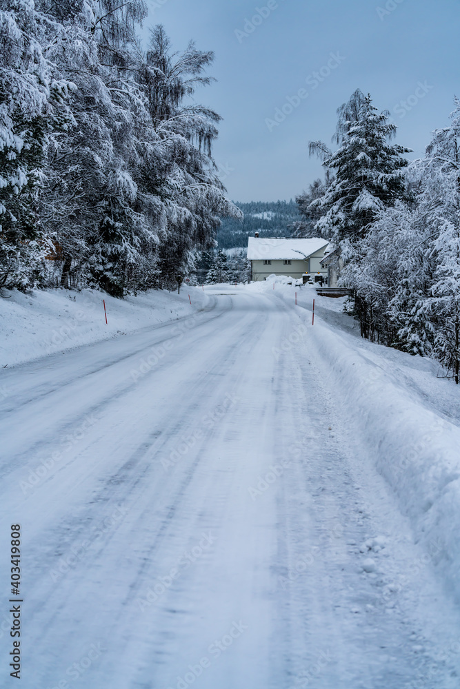 Fototapeta premium Road covered in ice and snow in the winter. Making it both slippery and dangerous.