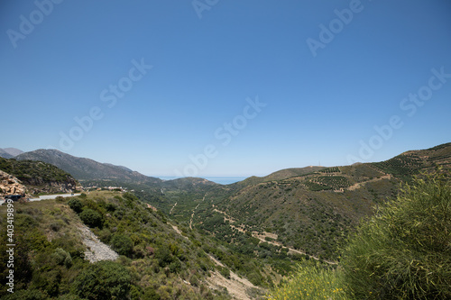 A view of the island is green mountains and plantations of olive trees.