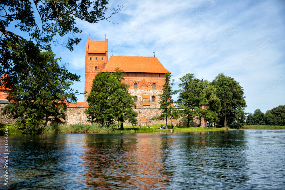 Fototapeta premium TRAKAI, LITHUANIA - JULY 29, 2017: Photo editor, A beautiful medieval castle surrounded by a lake close-up.