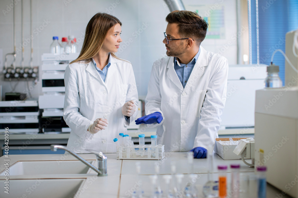 Group of young researchers analyzing chemical data in the laboratory Group of young researchers analyzing chemical data in the laboratory
