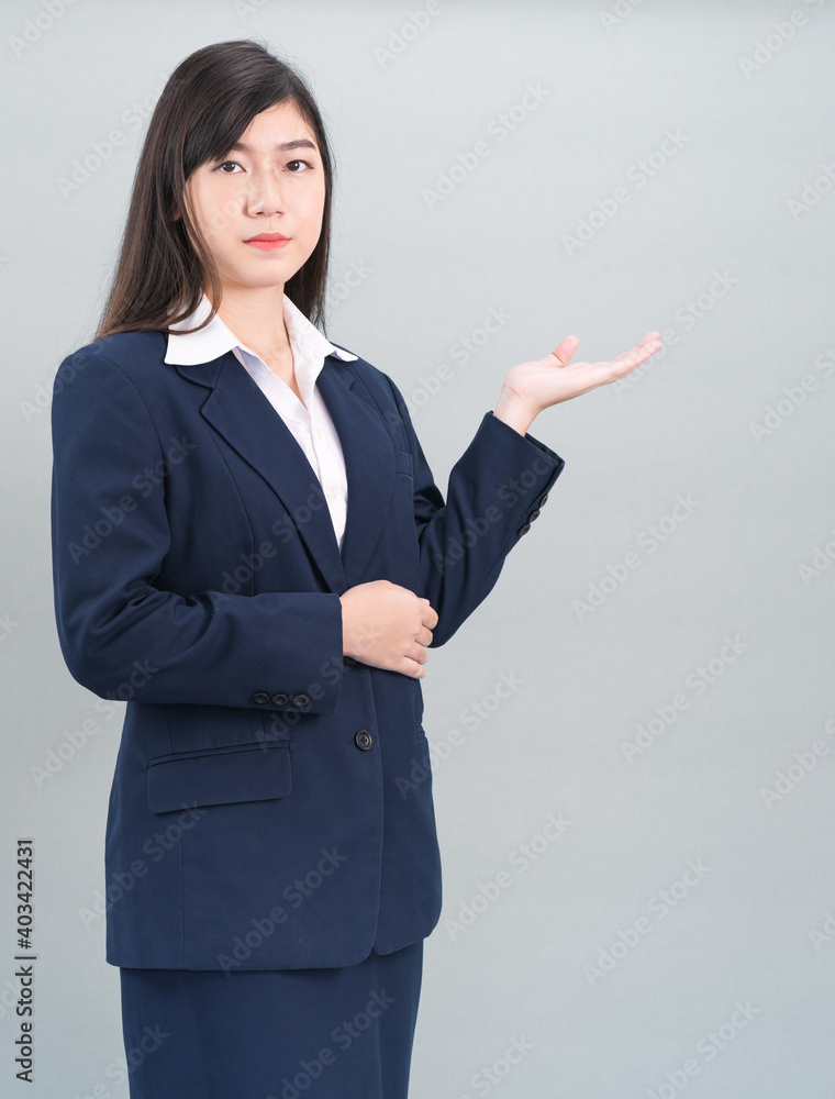 Asian woman in suit open hand palm gestures with empty space Asian woman in suit open hand palm gestures with empty space