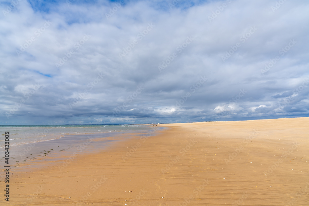 beautiful wide empty golden sand beach