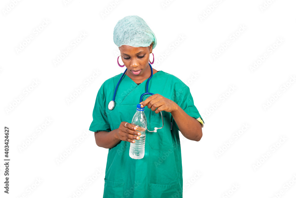young female doctor opening the bottle of mineral water. young female doctor opening the bottle of mineral water.