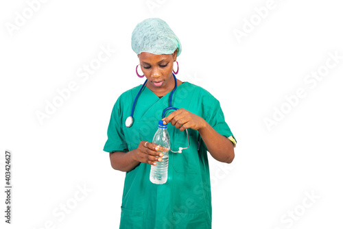 young female doctor opening the bottle of mineral water. © vystekimages