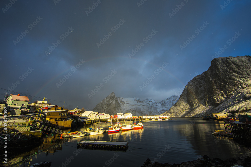 Lofoten Islands. Beautiful landscape. Red houses and boats against the backdrop of mountains and clouds.