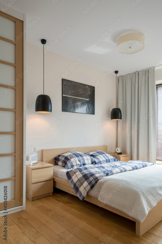 Fototapeta premium Modern bedroom with wooden furniture