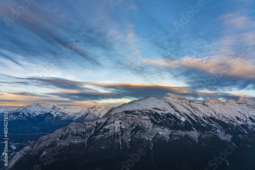 Snow capped Mount Rundle mountain range in beautiful dusk. Sky of red pink clouds in the background. Banff National Park in winter, Canadian Rockies. Beautiful nature scenery.