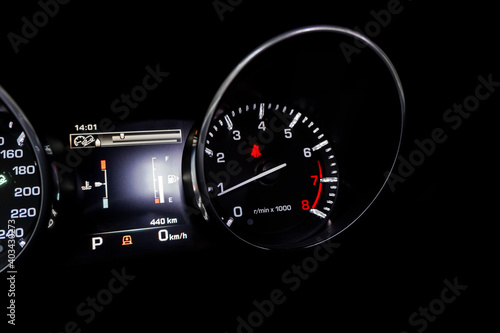Close up shot of a tachometer in a car. Car dashboard. Dashboard details with indication lamps. Car instrument panel. Dashboard with speedometer, tachometer, odometer. Car detailing.