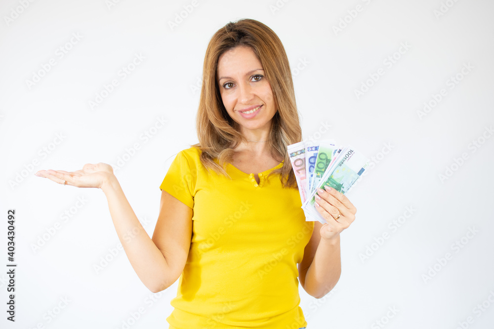 Portrait of a cheerful young woman holding money banknotes and celebrating isolated over white background Portrait of a cheerful young woman holding money banknotes and celebrating isolated over white background