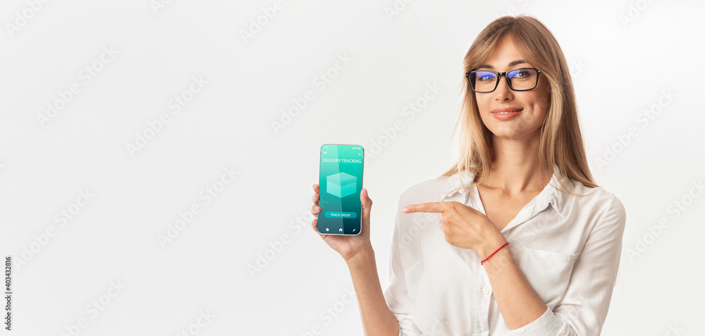 Woman holding cellphone with delivery tracking website Woman holding cellphone with delivery tracking website
