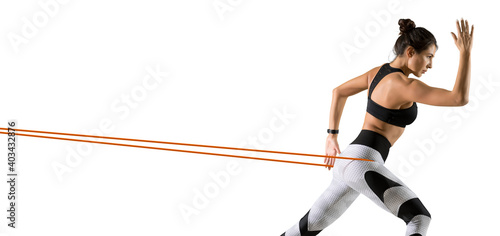 Fitness woman performs exercises with resistance band
