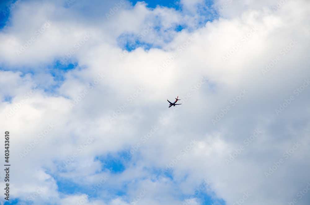 Blue sky and airplane on cumulus clouds background