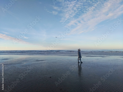 Girl on the background of the sea and blue sky coast of the English Channel in France in the city of Deauville. Travel across France. Woman traveler