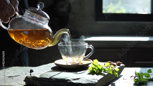 Slow motion Cup of hot tea  dry tea leaves with steam and mint herb.,hot food