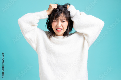 Nervous woman with panic expression portrait isolated on blue studio background