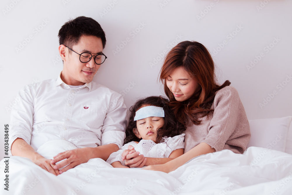 Asian sick girl sleeping on the bed with fever gel pack on her forehead. Asian sick girl sleeping on the bed with fever gel pack on her forehead.