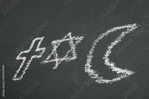 Obraz na plátně Star of David, Cross and Islamic Crescent on a blackboard
