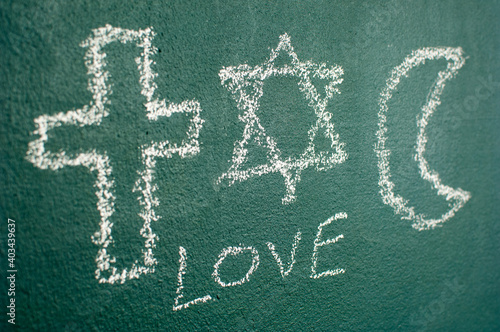 Photography Star of David, Cross and Islamic Crescent on a blackboard