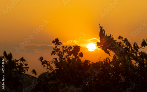 The sun rises statue of Naka Buddha and large Buddha statue at Mukdahan Province,Big Buddha Wat Phu Manorom Mukdahan Thailand. photo