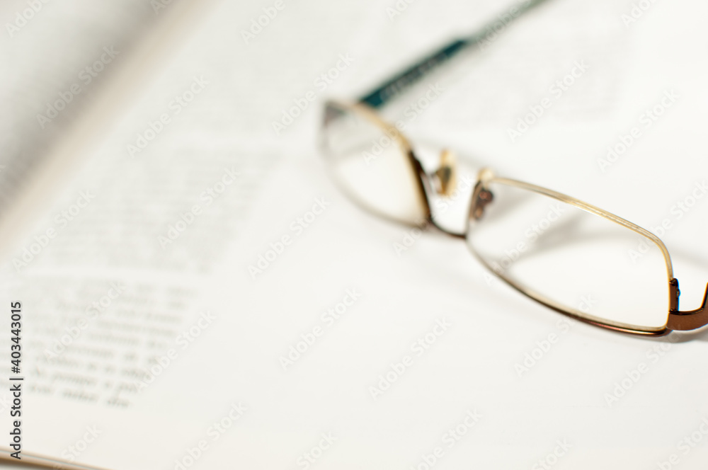 Reading glasses on an open book Reading glasses on an open book