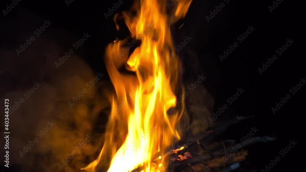 Women's hands close-up by the fire and fry sausages on the fire at night. Women's hands close-up by the fire and fry sausages on the fire at night.