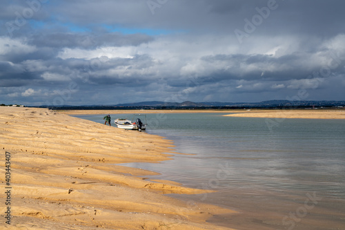 man collecting sand for crabmeal and fishing in the Ria Formosa River Delta