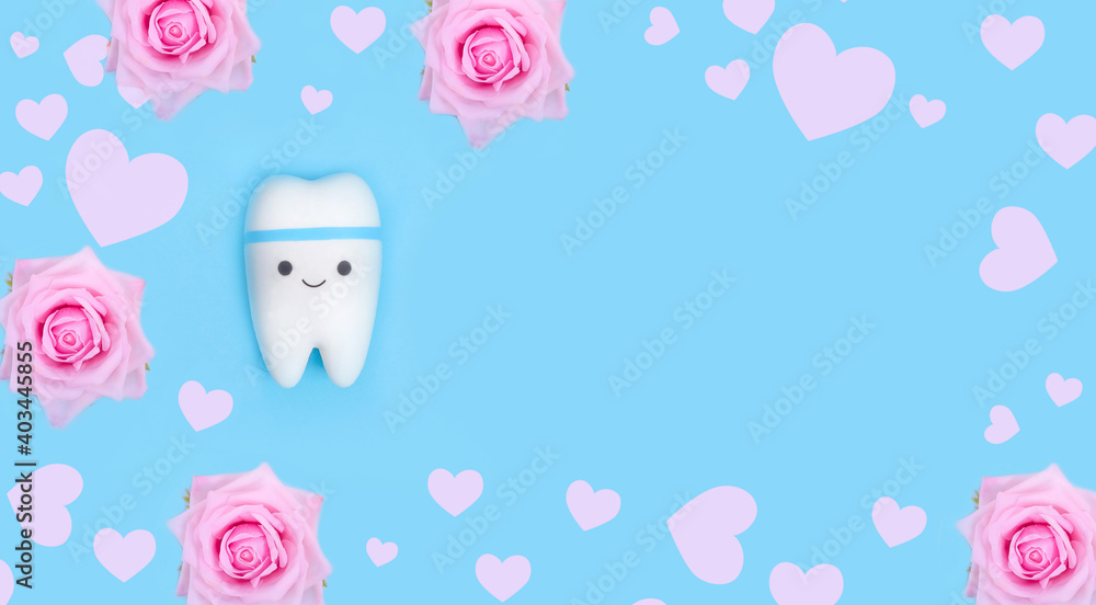 Valentine's day dentistry background banner. Tooth model with copy space with frame of pink hearts and roses Valentine's day dentistry background banner. Tooth model with copy space with frame of pink hearts and roses