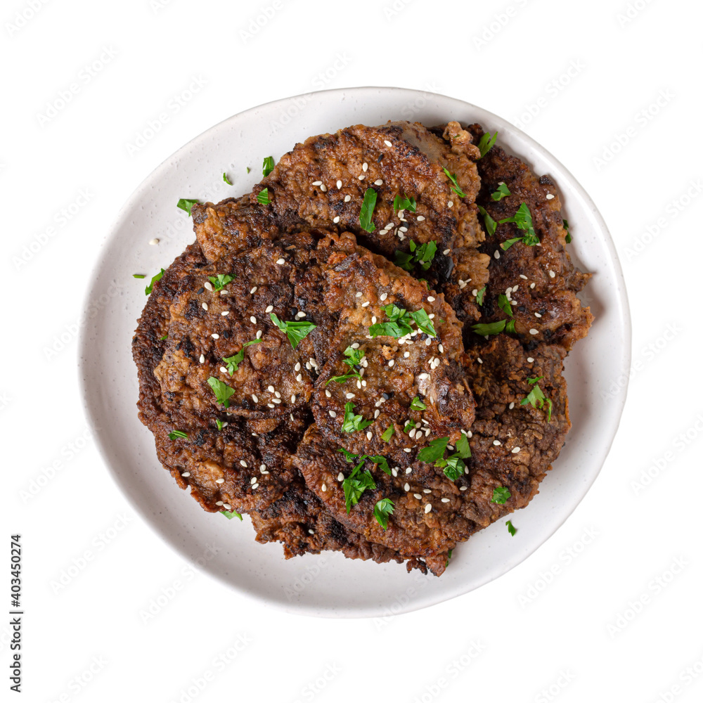 Fried liver pieces on a plate isolated on a white background. Top view. Fried liver pieces on a plate isolated on a white background. Top view.
