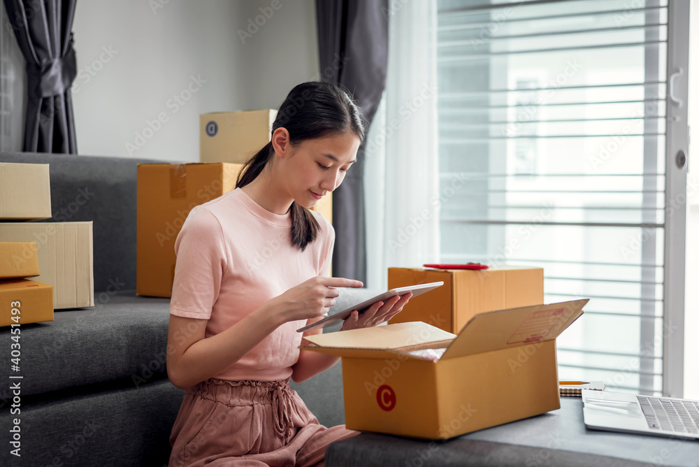 Young Asian woman selling online at home. Young Asian woman selling online at home.