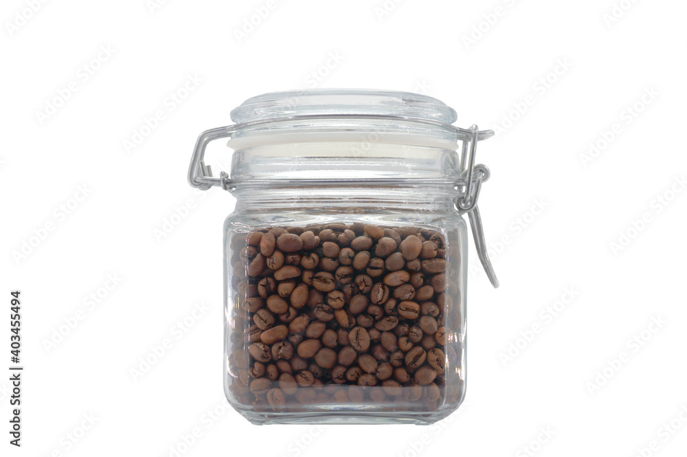 A glass jar filled with coffee beans and closed with a clip-on lid. Isolated on light gray background. A glass jar filled with coffee beans and closed with a clip-on lid. Isolated on light gray background.