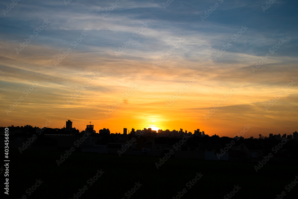 Photos of the sunset at the end of the day with the outline of the buildings in londrina, parana, brazil