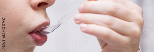 spoon with syrup in the child's mouth