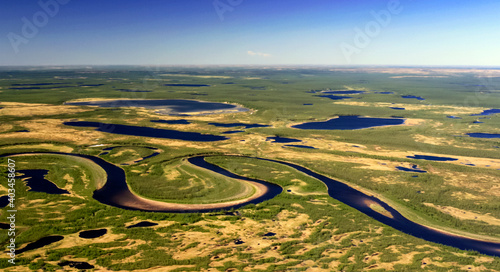Fotografie Northern tundra with rivers, lakes and swamps in the spring from a helicopter