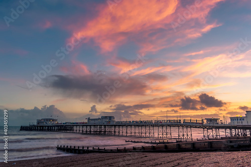 A fiery sky above the beach and pier at Worthing  Sussex  UK at sunset