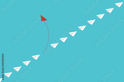 Think differently. Red airplane changing direction. New idea, change, trend, courage, creative solution, innovation and unique way concept.	