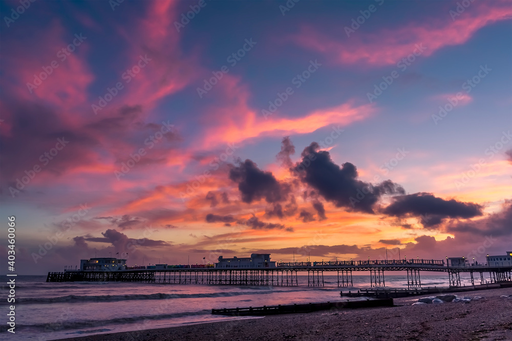The sunset above the Victorian pier at Worthing, Sussex, UK