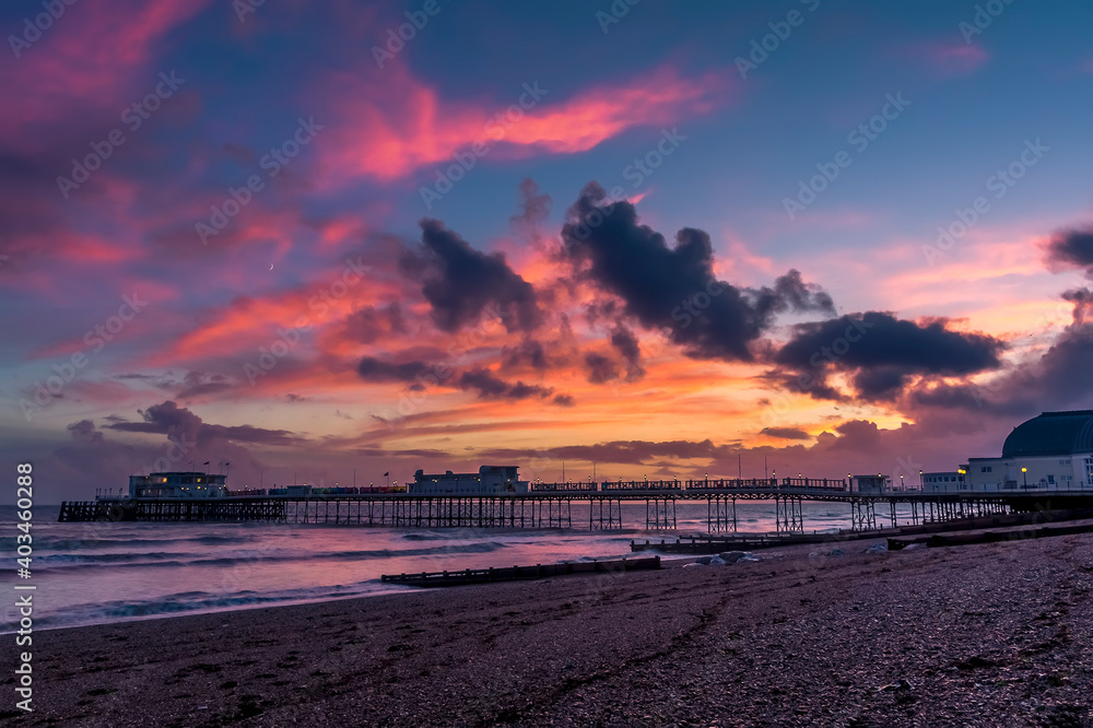 A spectacular sunset display above the shore and sea at Worthing, Sussex, UK