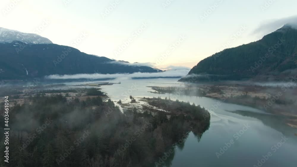 Aerial Canadian Nature Landscape with mountains in background. Sunny Sunrise Sky. Taken in Squamish, North of Vancouver, British Columbia, Canada.