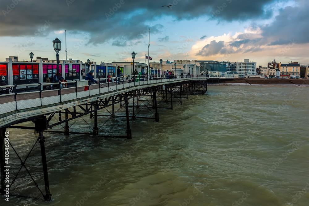 A view from the pier towards the town of Worthing, Sussex, UK at sunset