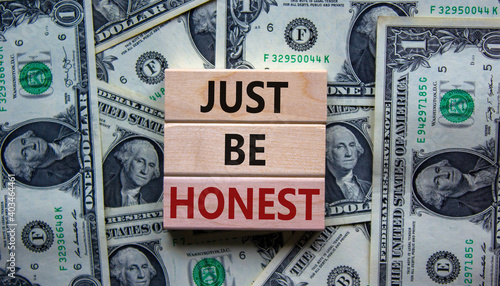Just be honest symbol. Concept words 'Just be honest' on wooden blocks on a beautiful background from dollar bills. Business and just be honest concept. Copy space.