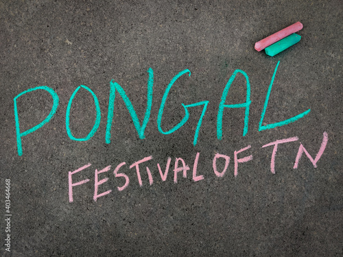 The inscription text on the grey board, Pongal Festival of TN(tamilnadu). Using color chalk pieces.