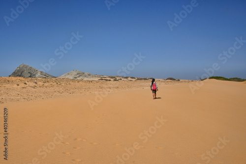 Woman walking in the desert of Cabo de la Vela, Guajira, Colombia