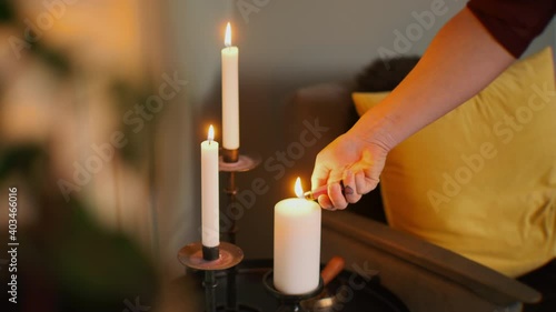A person lighting tree candles to create a relaxing atmosphere photo