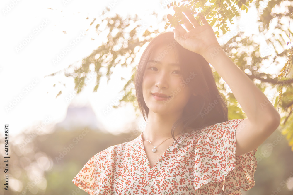 Young beautiful Asian woman enjoying her time on picnic blanket in beautiful natural park Young beautiful Asian woman enjoying her time on picnic blanket in beautiful natural park