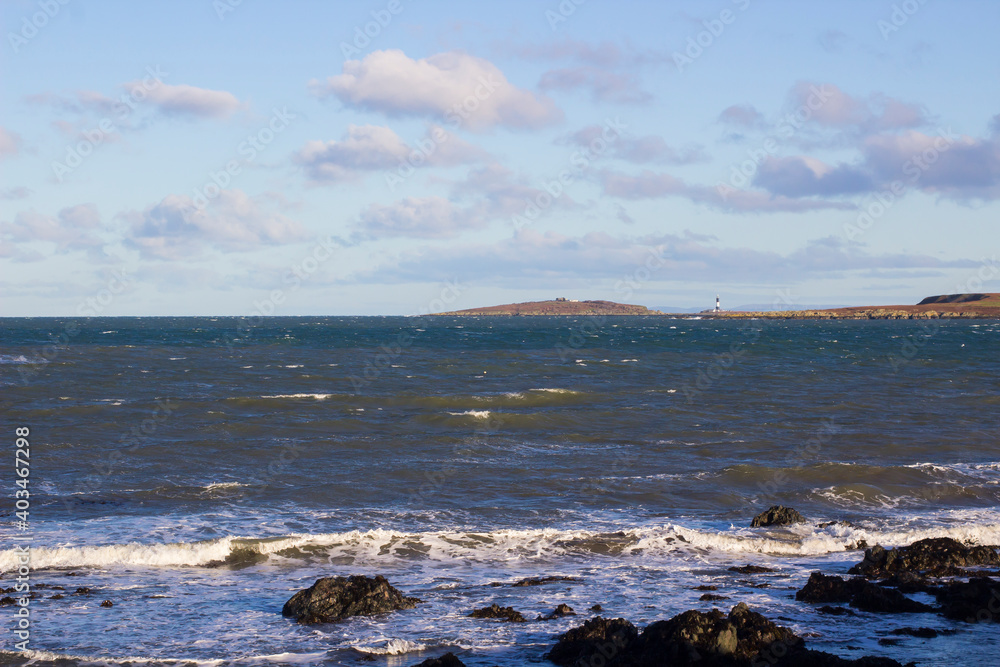 24 December 2020 A view of the rough seas across the Copeland Sound towards the Copeland Islands an a bright winter afternoon. The Mew Island Lighthouse is located on in the sound close to the Irish 24 December 2020 A view of the rough seas across the Copeland Sound towards the Copeland Islands an a bright winter afternoon. The Mew Island Lighthouse is located on in the sound close to the Irish