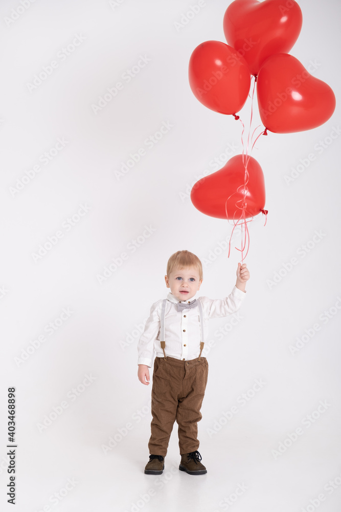 baby toddler boy in suit holding heart balloon on white background. Valentine Day and love concept. baby toddler boy in suit holding heart balloon on white background. Valentine Day and love concept.