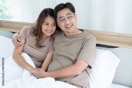 Senior Asian couple relaxing at home, Happy retirement life. © Basicdog